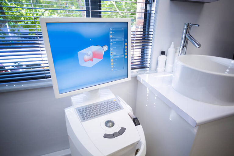 dental workstation featuring a computer monitor displaying a 3D model.